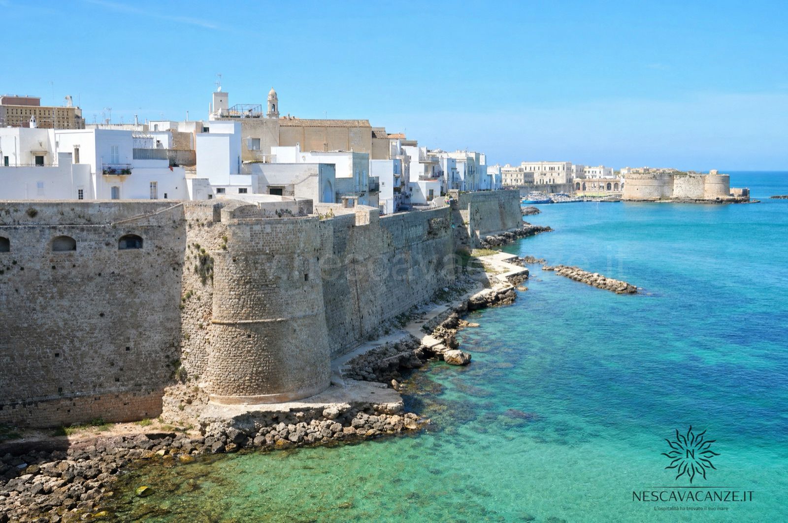 Il borgo bianco di Otranto con il castello aragonese affacciato sul mare turchese, nel Salento