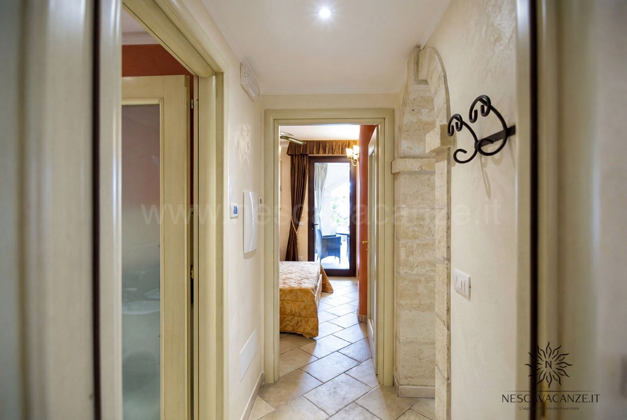 Casa Pescoluse 6 - corridoio interno con pavimento in cotto e vista sulla camera da letto