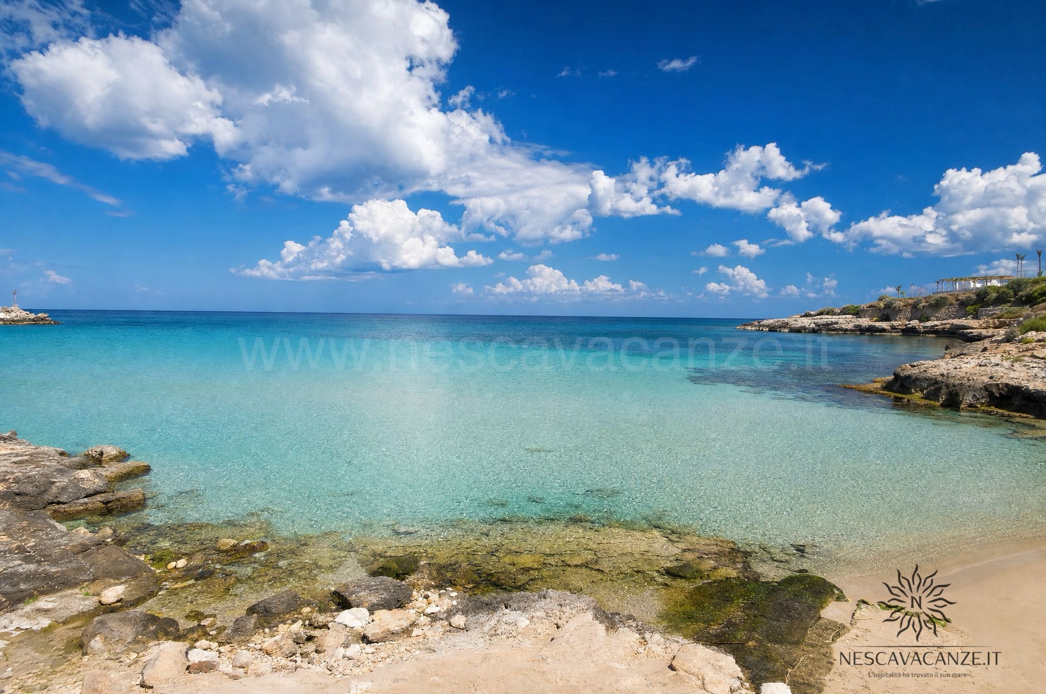 Cala con scogli piatti e acqua bassa cristallina a Torre Vado